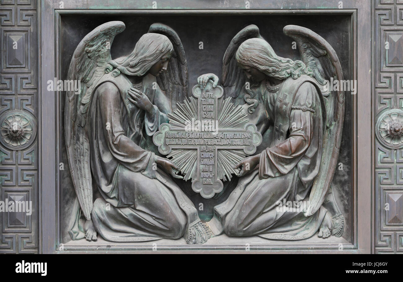 Two angels at the base of the doors of the southern facade of St. Isaac`s Cathedral, St. Petersburg, Russia Stock Photo